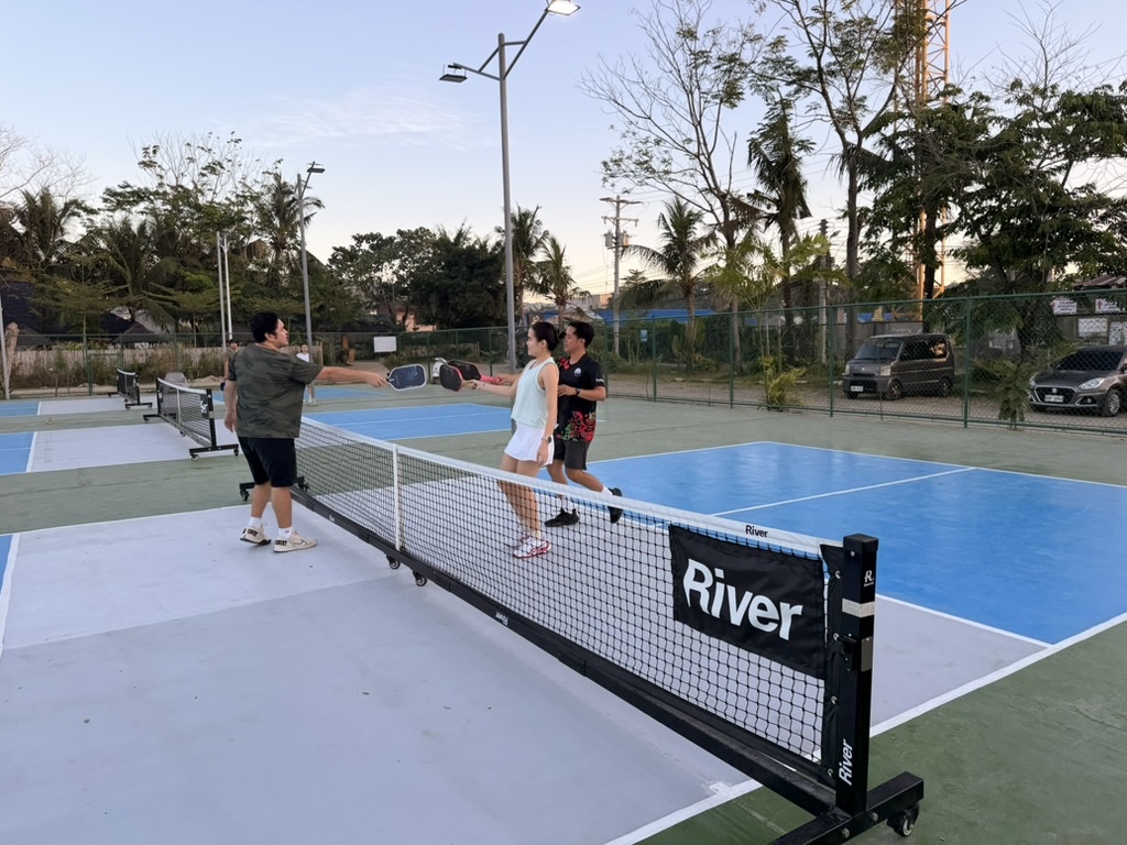 Challengers approach the net to take on the defending team