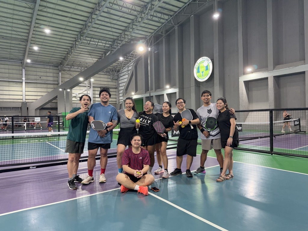 A team celebrating at the end of an indoor pickleball night